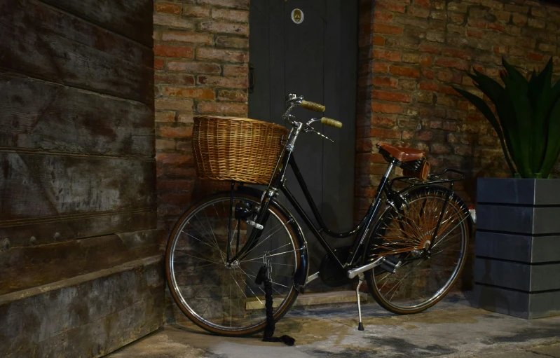 a bicycle is parked near a tall brick building