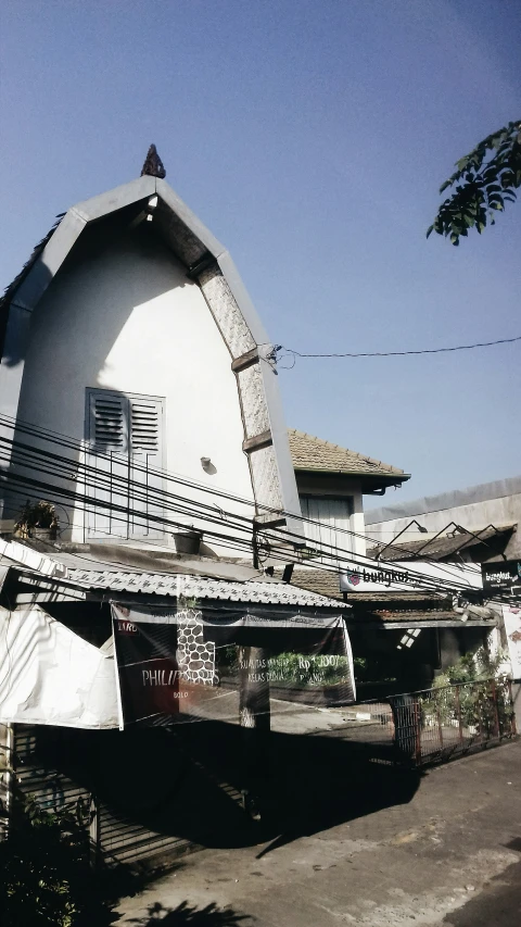 a building that has a white roof with a long metal roof