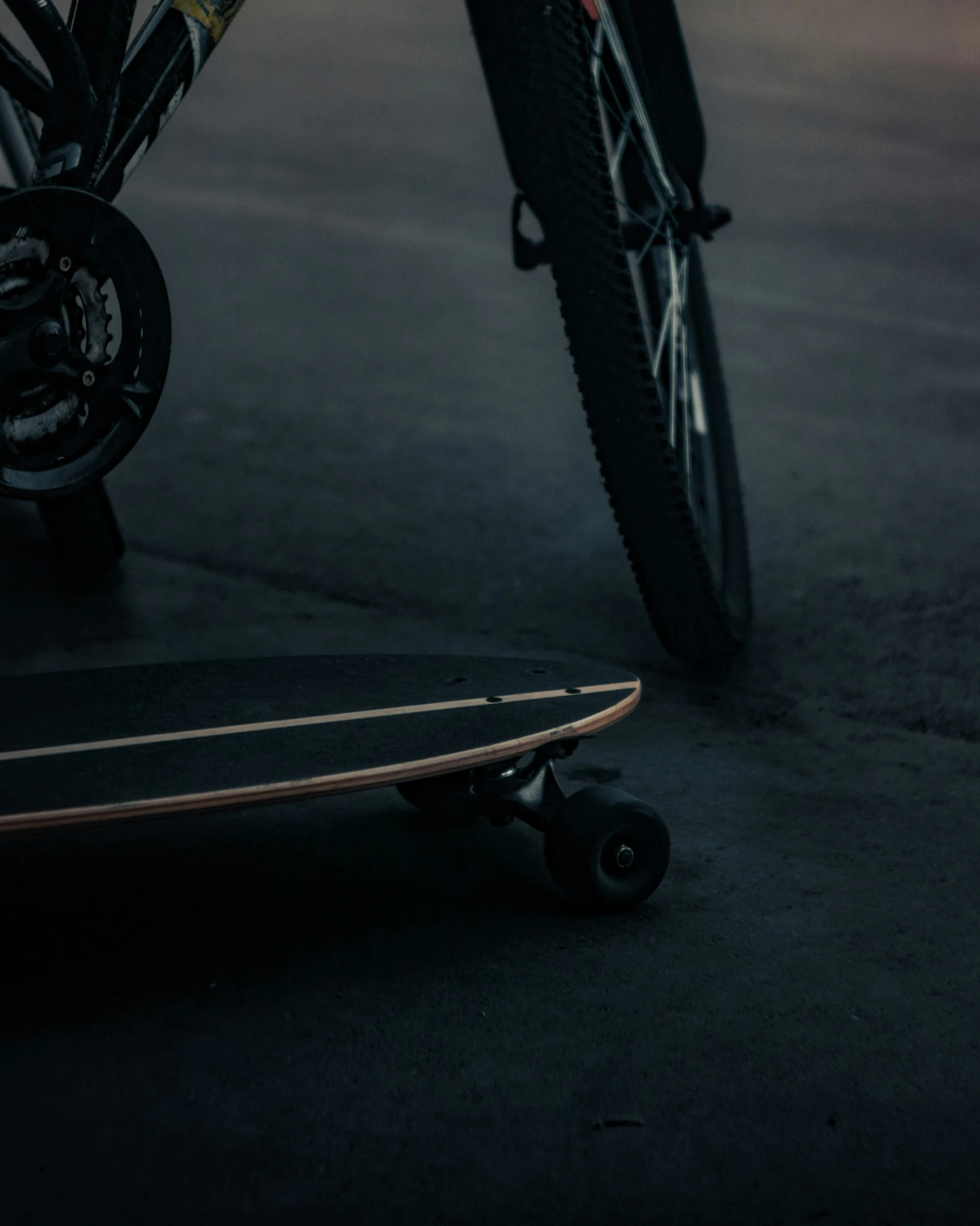 a skateboard sitting in front of a bicycle