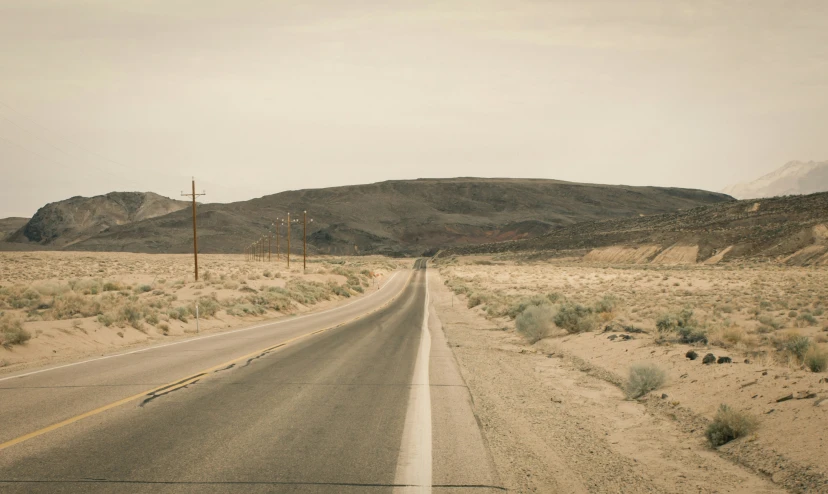 the view from the road shows a deserted deserted desert