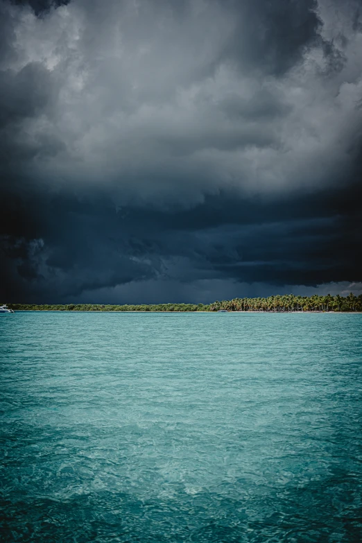 there are some dark clouds and blue water