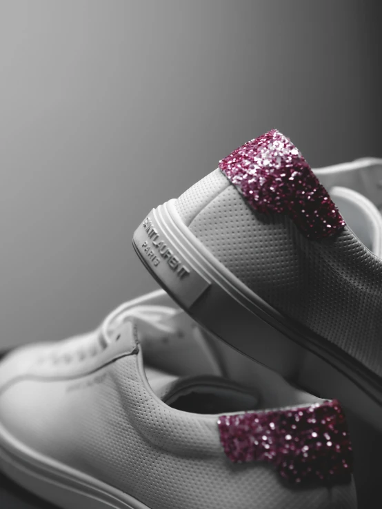 pair of shoes with sparkling pink bow on top