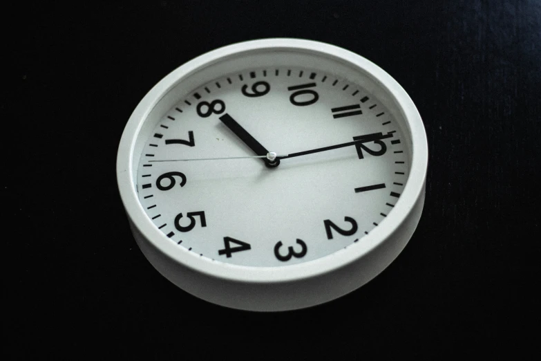 a small white clock on a black background