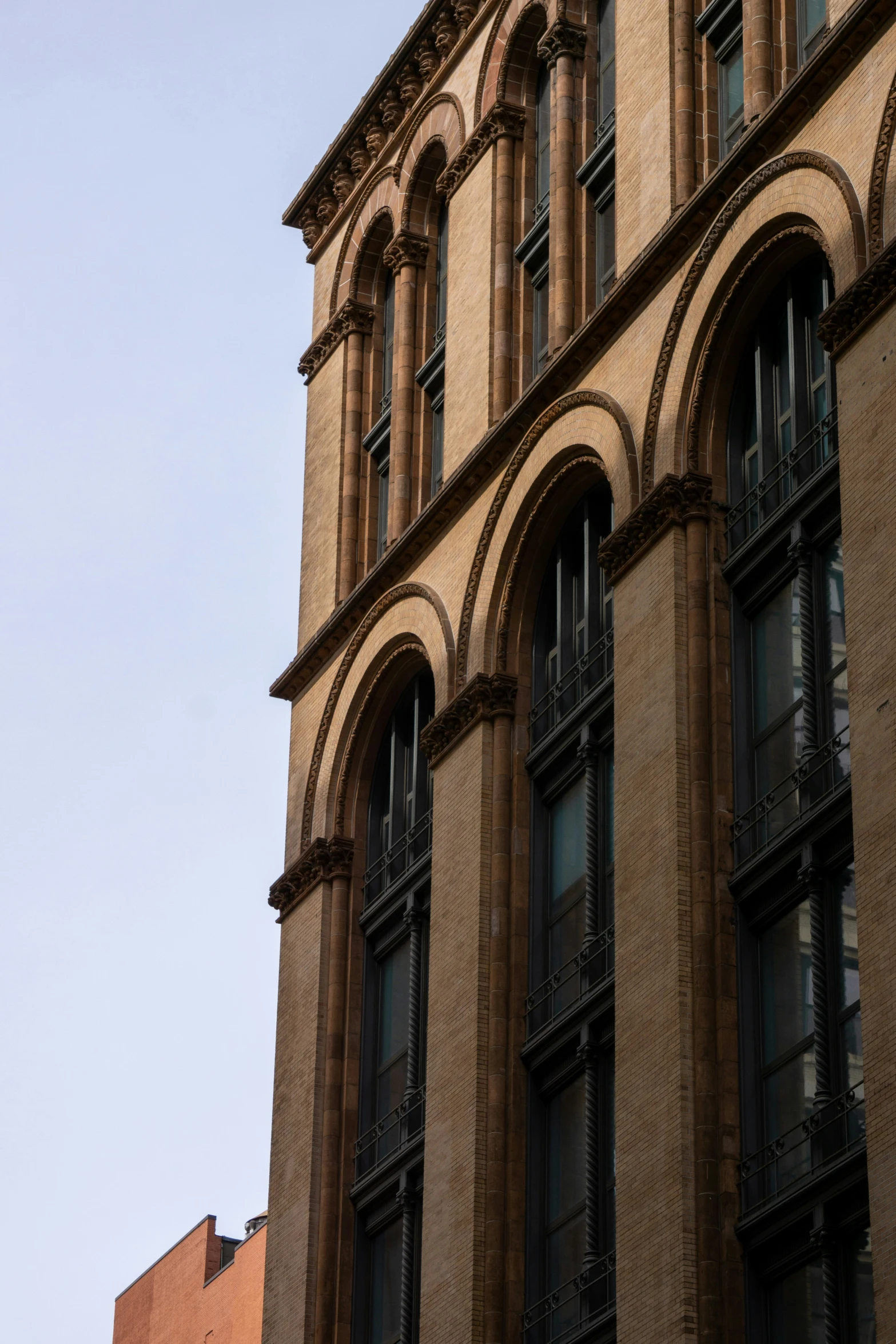 large window frames on the side of a brick building