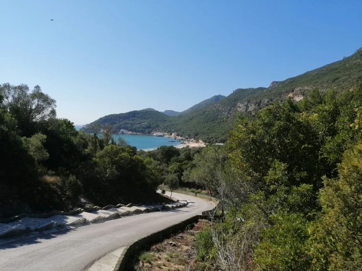 a winding road that leads down to the ocean