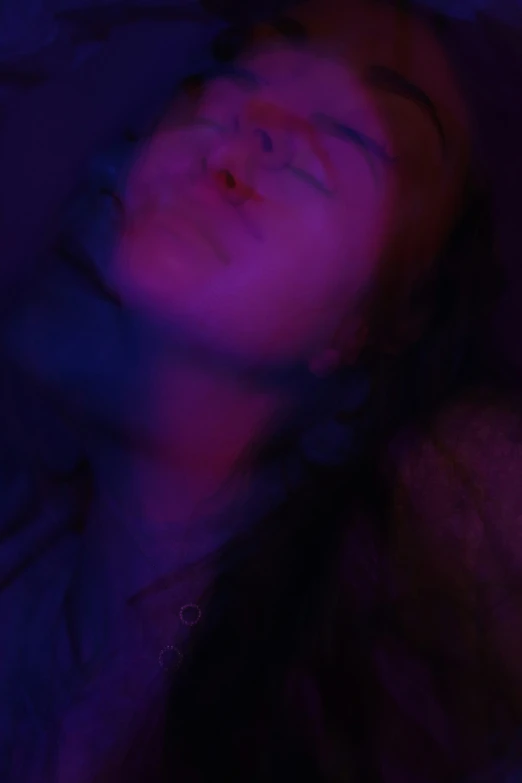 the person in a purple light is sleeping