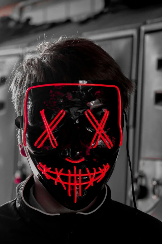 a boy wearing a scary mask while standing in front of lockers