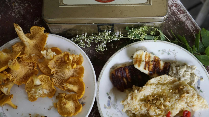 plates with mushrooms next to food sitting on a table