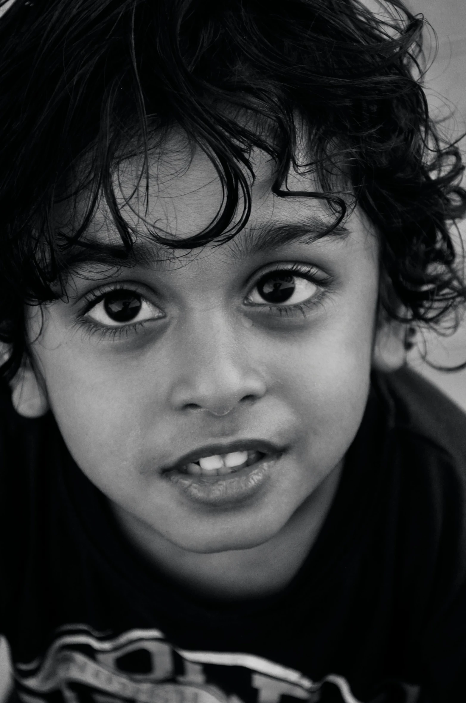 a young child with eyes open wearing a scarf