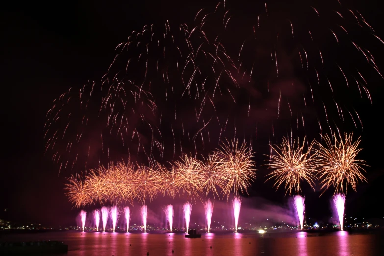 fireworks lit up the sky above a body of water