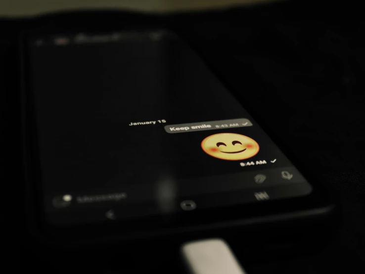 a black phone with emoticting smiley faces
