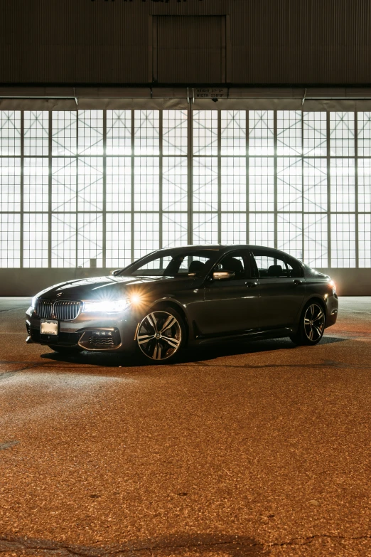 the car is parked inside of an empty parking garage