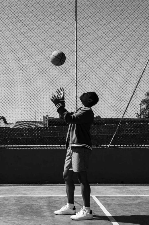 a black and white image of a tennis player holding a tennis ball