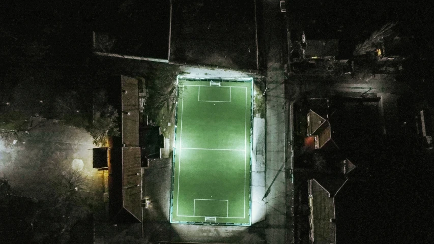 an overhead view of a lit up sports field