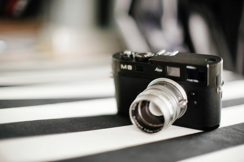 a small camera is on a table with white stripes