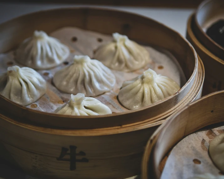 dimming dumplings in wooden containers on a table