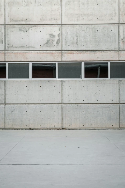 a man riding a skateboard next to a wall