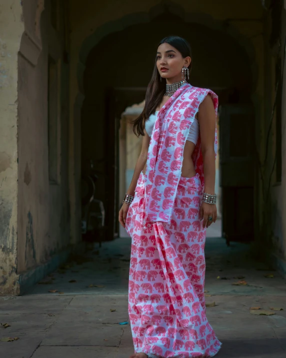 woman in traditional indian attire walking down hallway