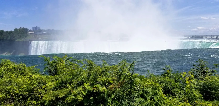 the water gushing from a waterfall is shown