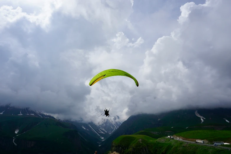 a person is parasailing in a cloudy sky