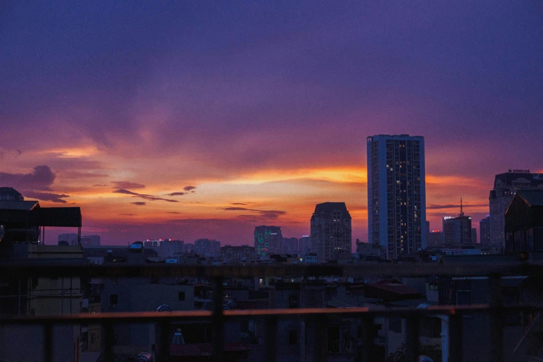 the skyline of a city is lit up at sunset