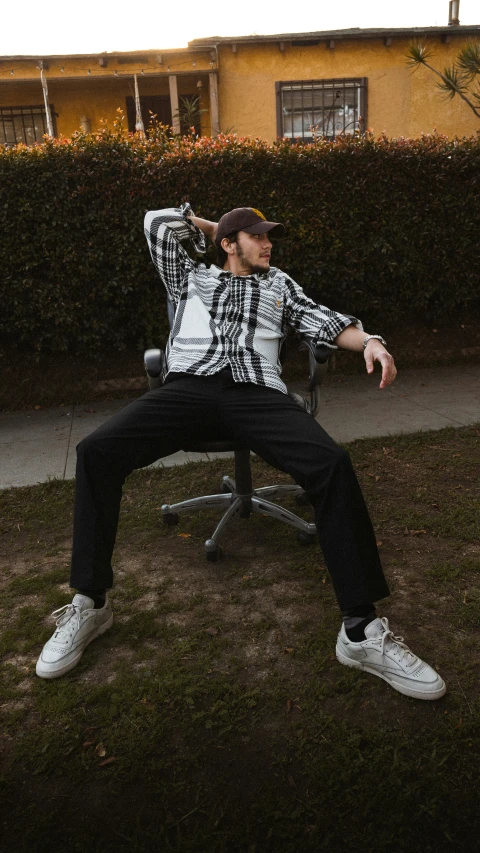 the man is relaxing in his office chair outside