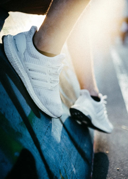 a person is sitting on a bench and a skateboard