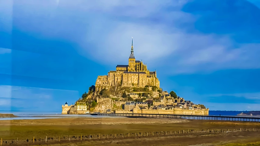 a very large castle sitting next to a large body of water