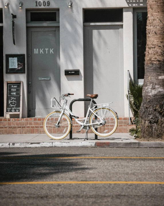 a bicycle parked in front of an apartment building