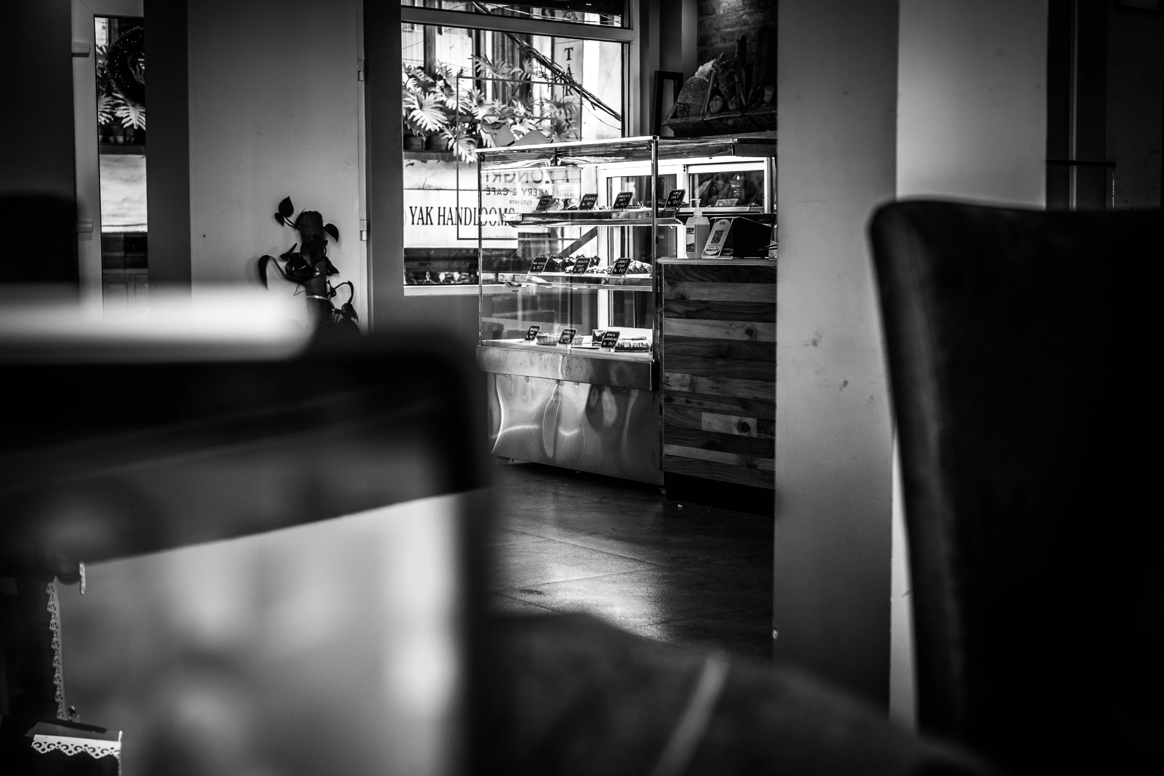 the interior of an empty restaurant with wood and brick wall