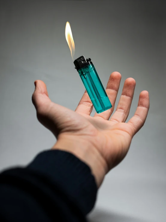 someone holding out their hand to light an lighter