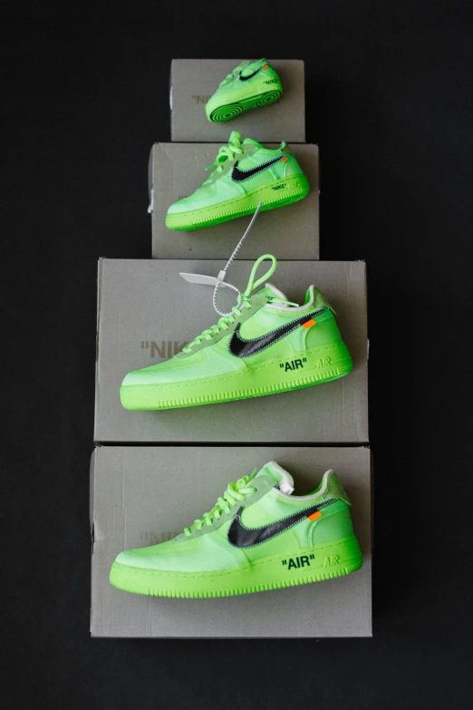 the three shoes are glow green with black on them