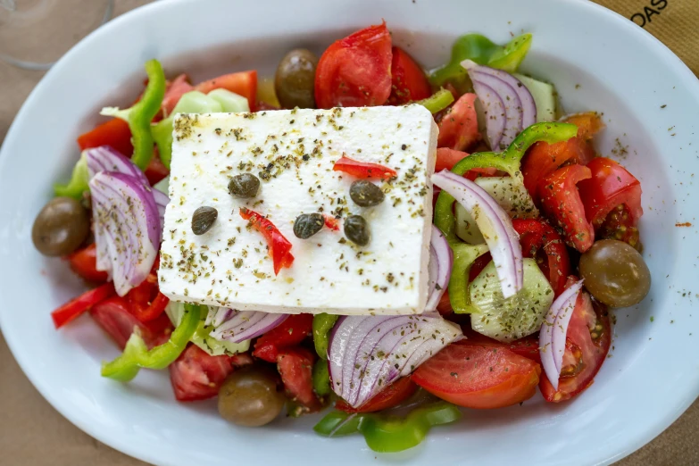 a plate filled with sliced vegetables and cheese