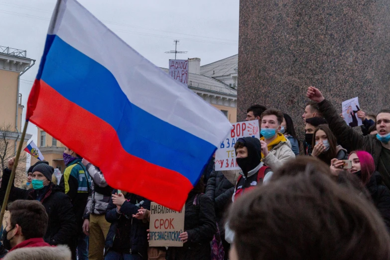 a crowd of people with protest signs and flags