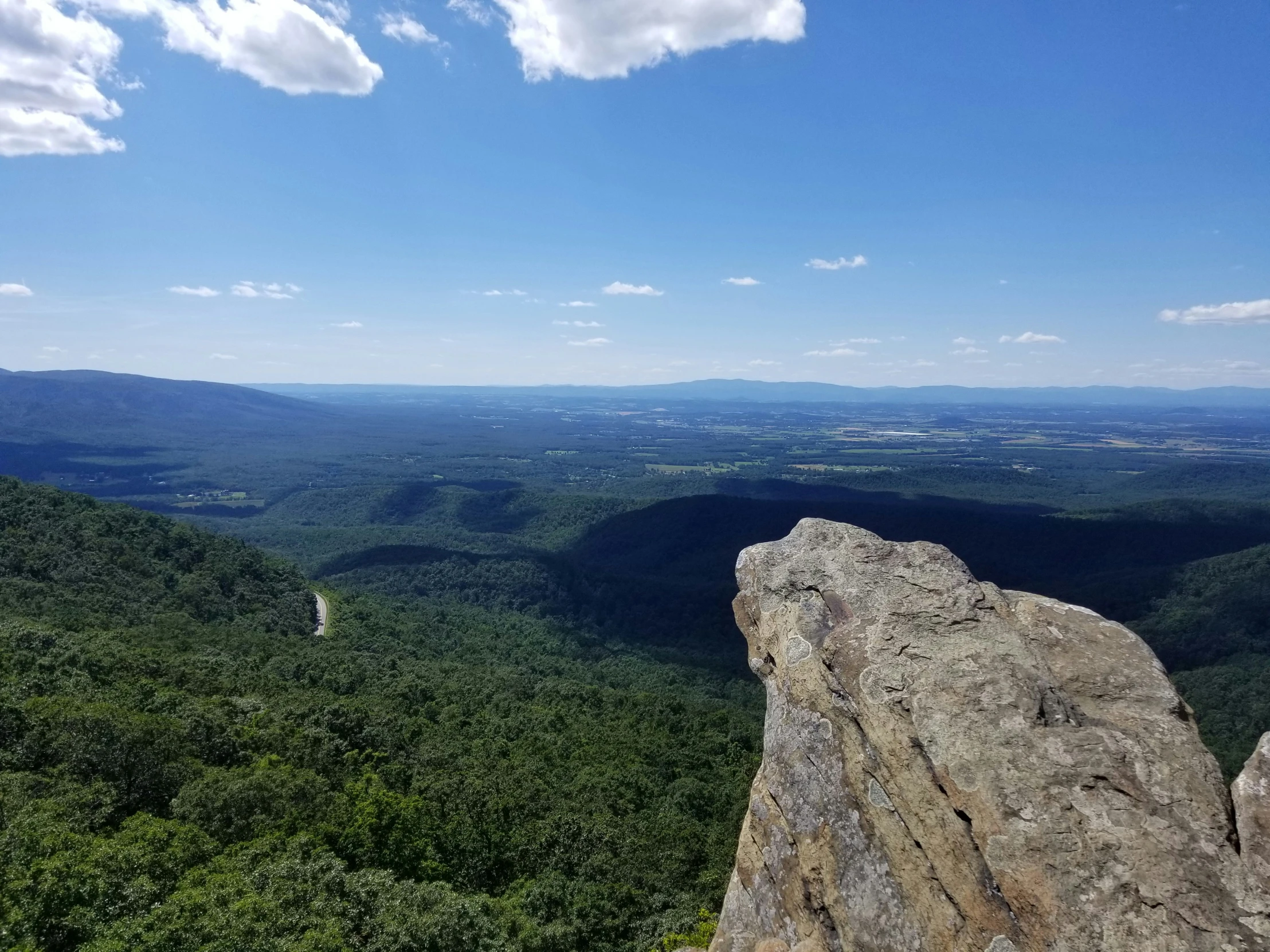 there is a hiker that is looking out over the mountains