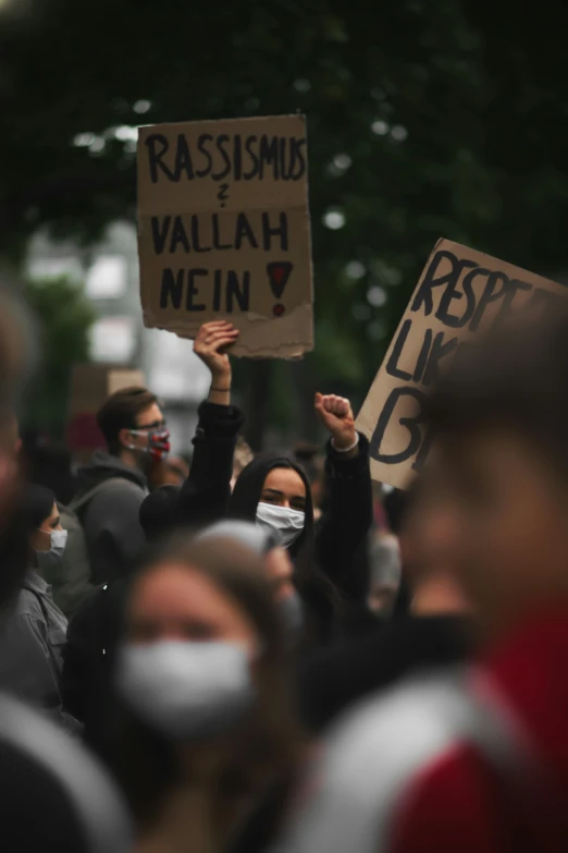 a group of people holding signs during a protest