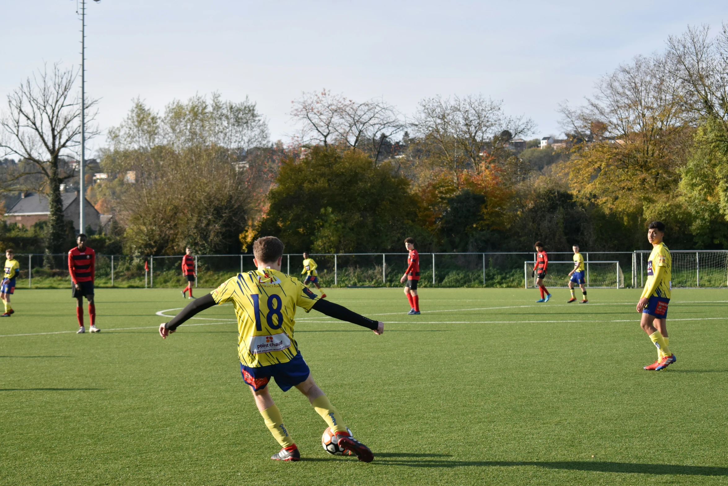 the young people are playing soccer on the field