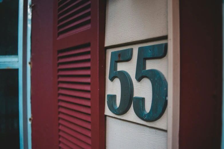 this is an image of a door and number on the side of a building