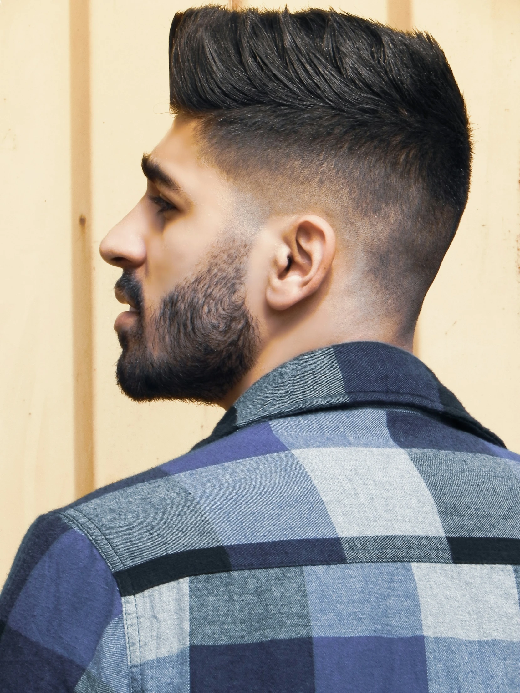 the back view of a man with a long fade undercut