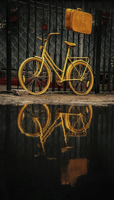 a bike with a back bag is parked in front of the fence