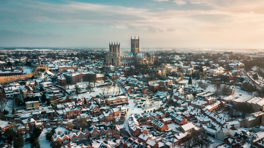 an aerial view of a snowy town in england