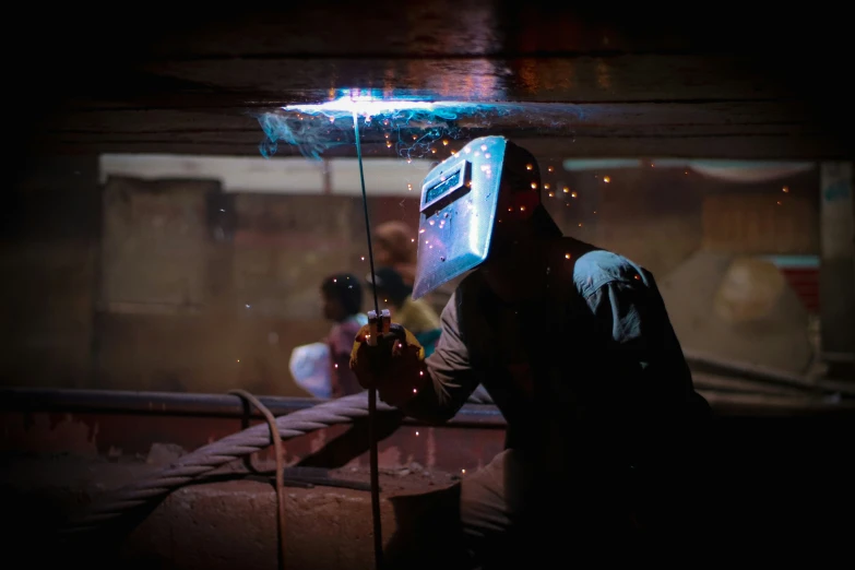 a person is welding soing that's on their head