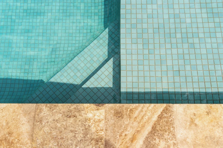 a shadow on the ground by a pool