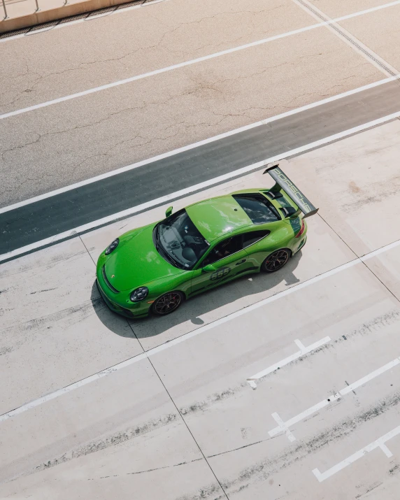 a sports car parked in a parking lot, from above