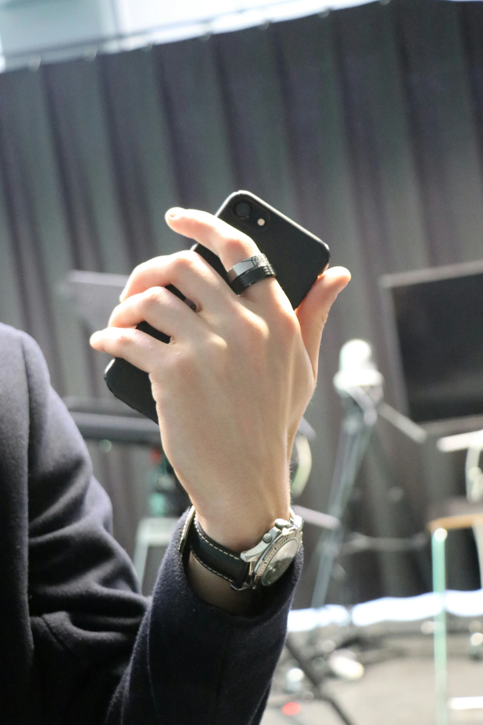 a person in a suit holds up a smart phone