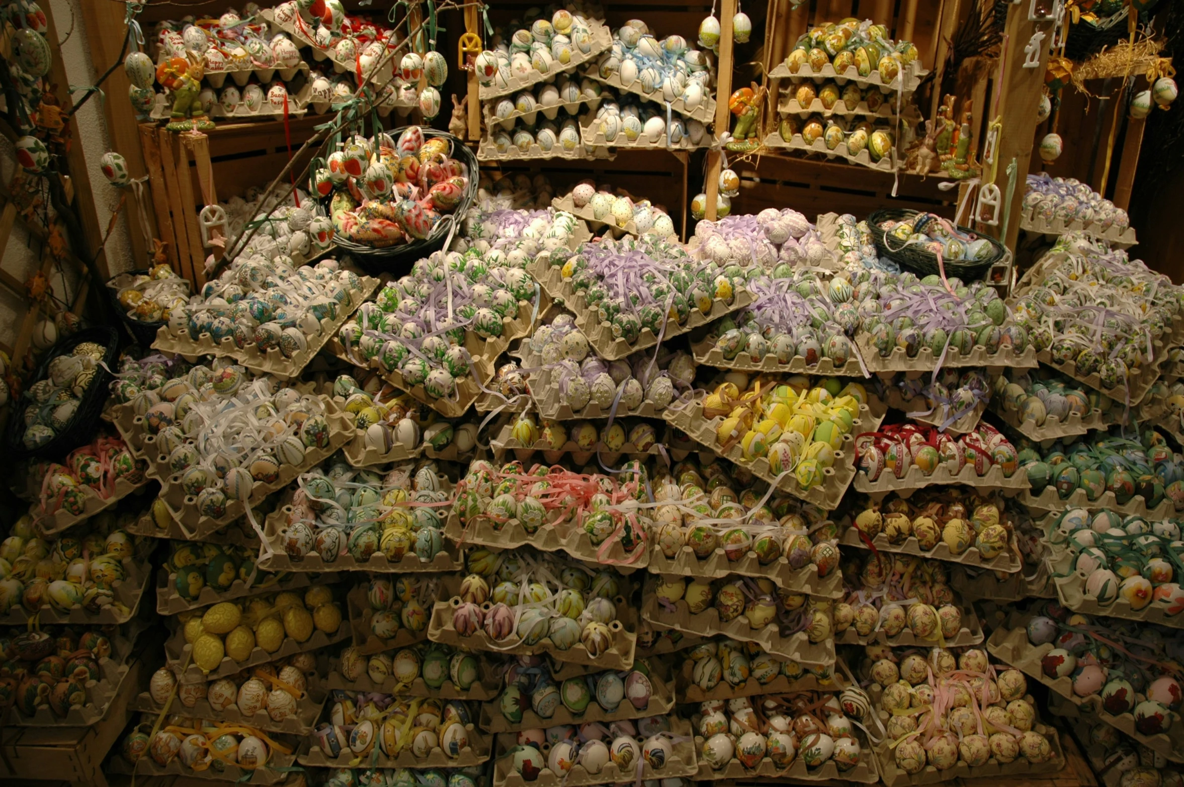 a bunch of colorful decorated eggs and other things for sale