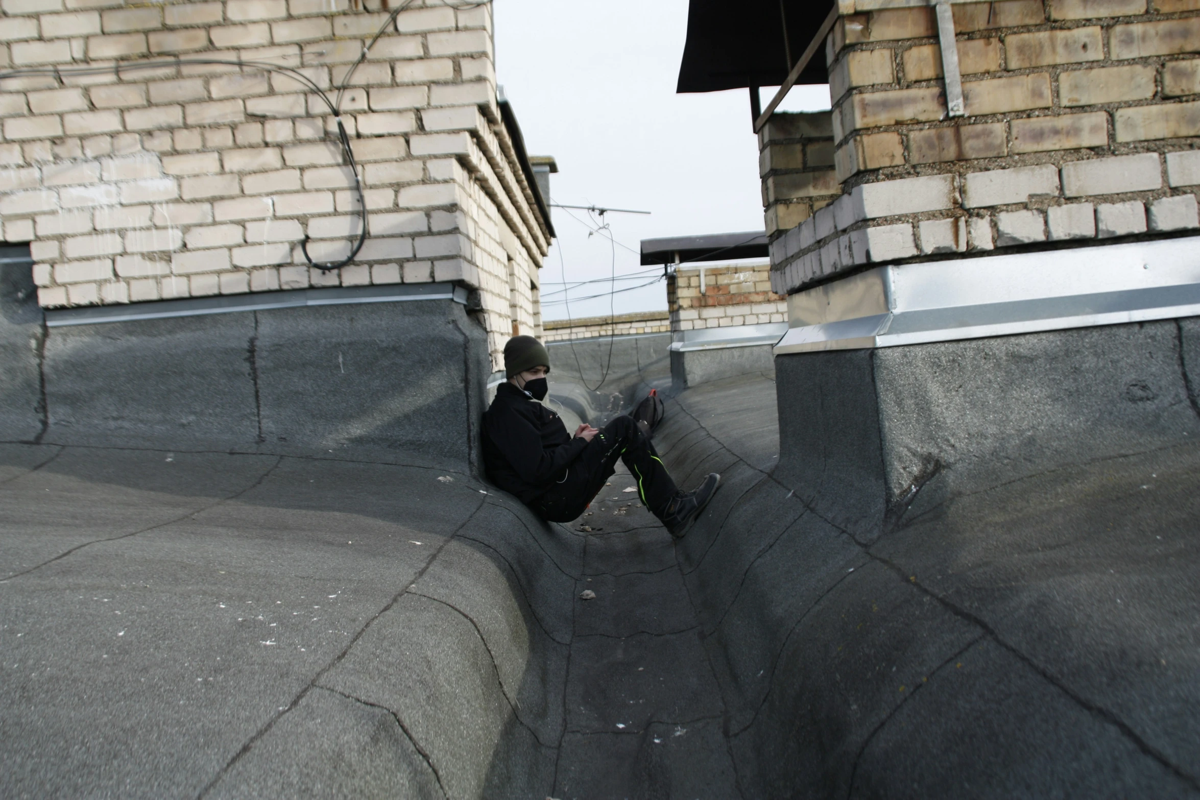 a man sitting on the edge of a skate ramp