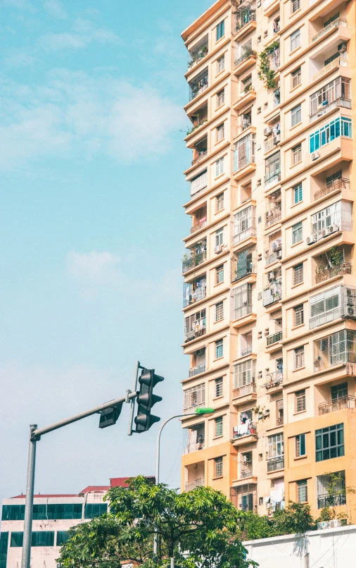 a tall apartment building next to a traffic signal