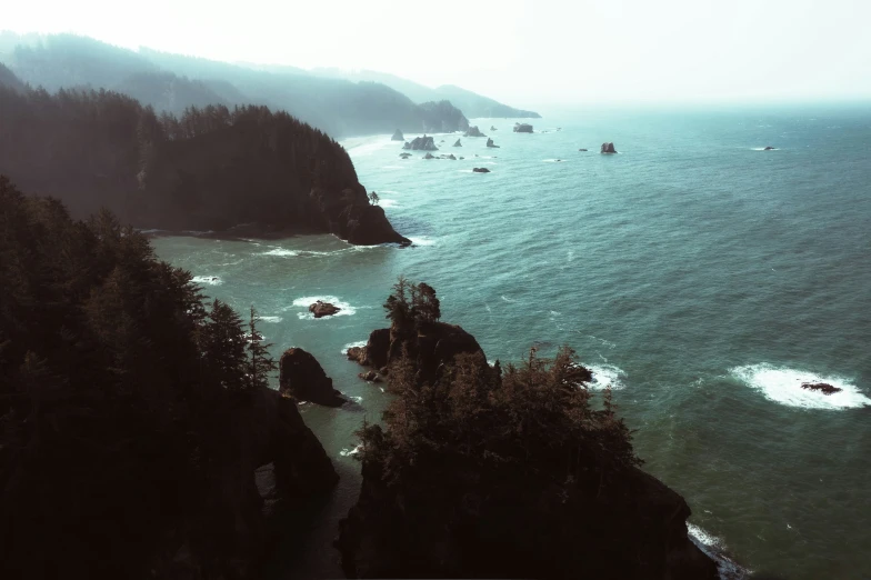 a group of boats in the ocean near a big hill