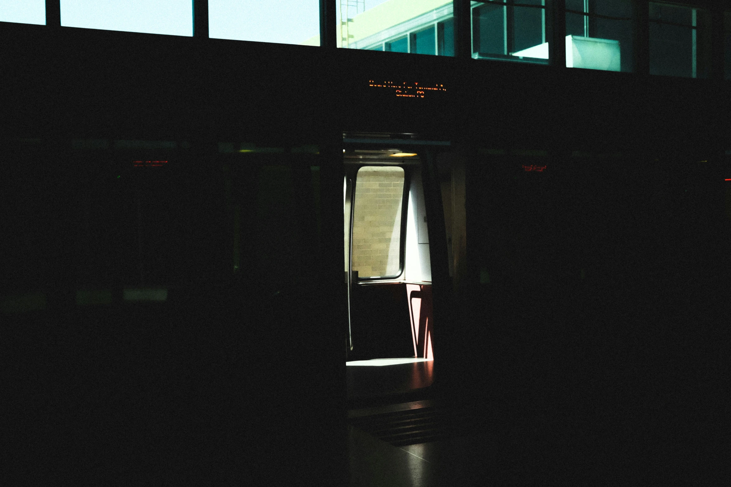 a door opened to a building with a window